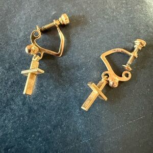 Pre loved vintage gold-tone clip-on earrings with a dangling cross charm.